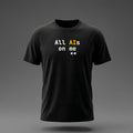 Front view: Black t-shirt floating on a grey background with 'All AIs on me' stacked on two lines with small pixel eyes below printed across the chest in off-white and amber.