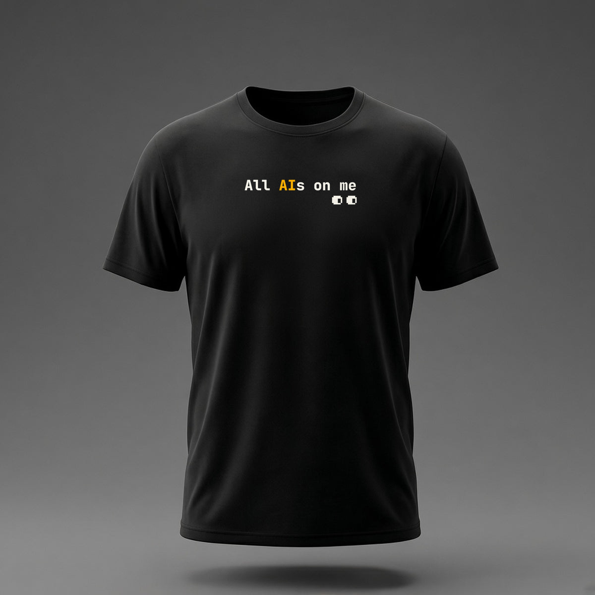 Front view: Black t-shirt floating on a grey background with 'All AIs on me' on one line with pixel eyes printed across the chest in off-white and amber.