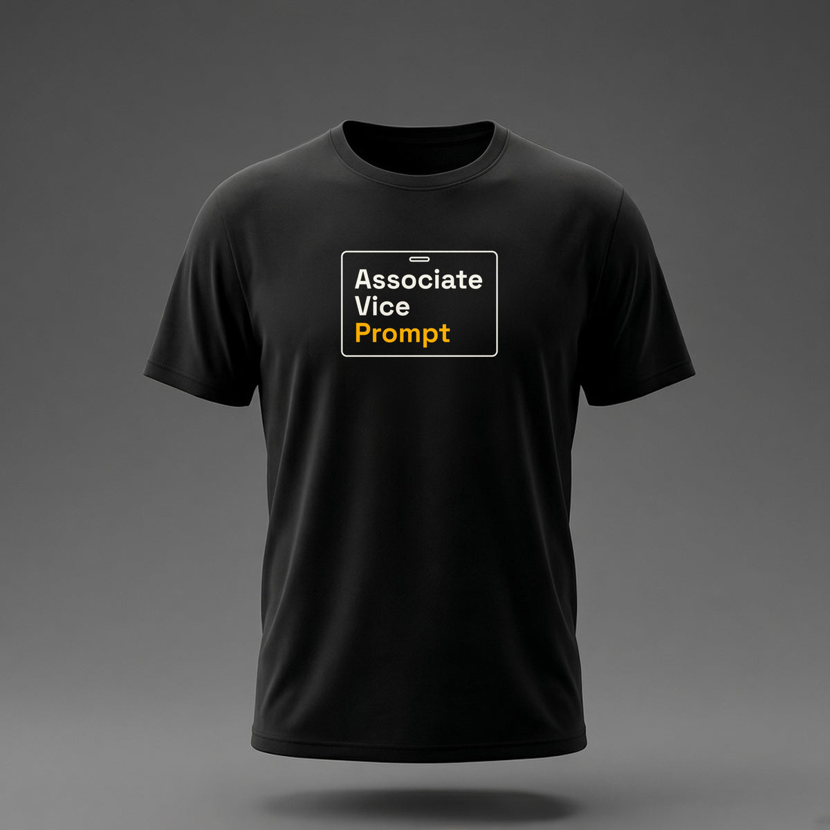Front view: Black t-shirt floating on a grey background with 'Associate Vice Prompt' on an ID-badge outline printed across the chest in off-white and amber.