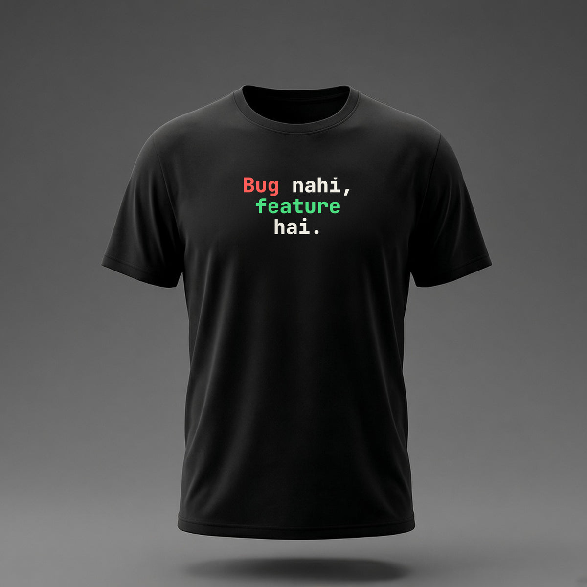 Front view: Black t-shirt floating on a grey background with 'Bug nahi, feature hai.' in three heavy mono lines printed across the chest in off-white, red and green.