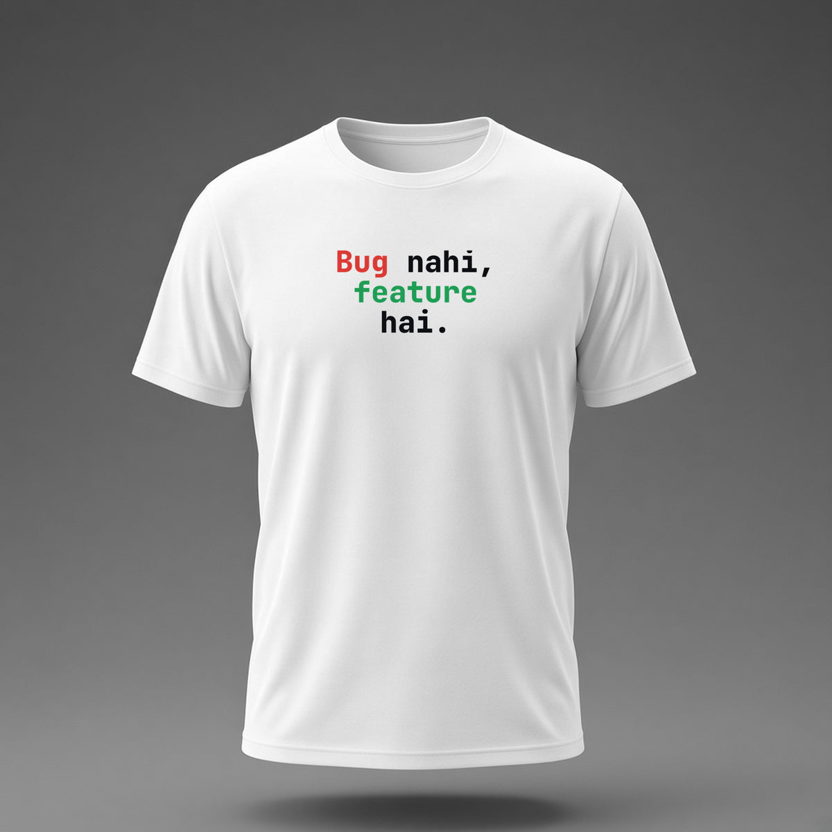 Front view: White t-shirt floating on a grey background with 'Bug nahi, feature hai.' in three heavy mono lines printed across the chest in black, dark red and dark green.