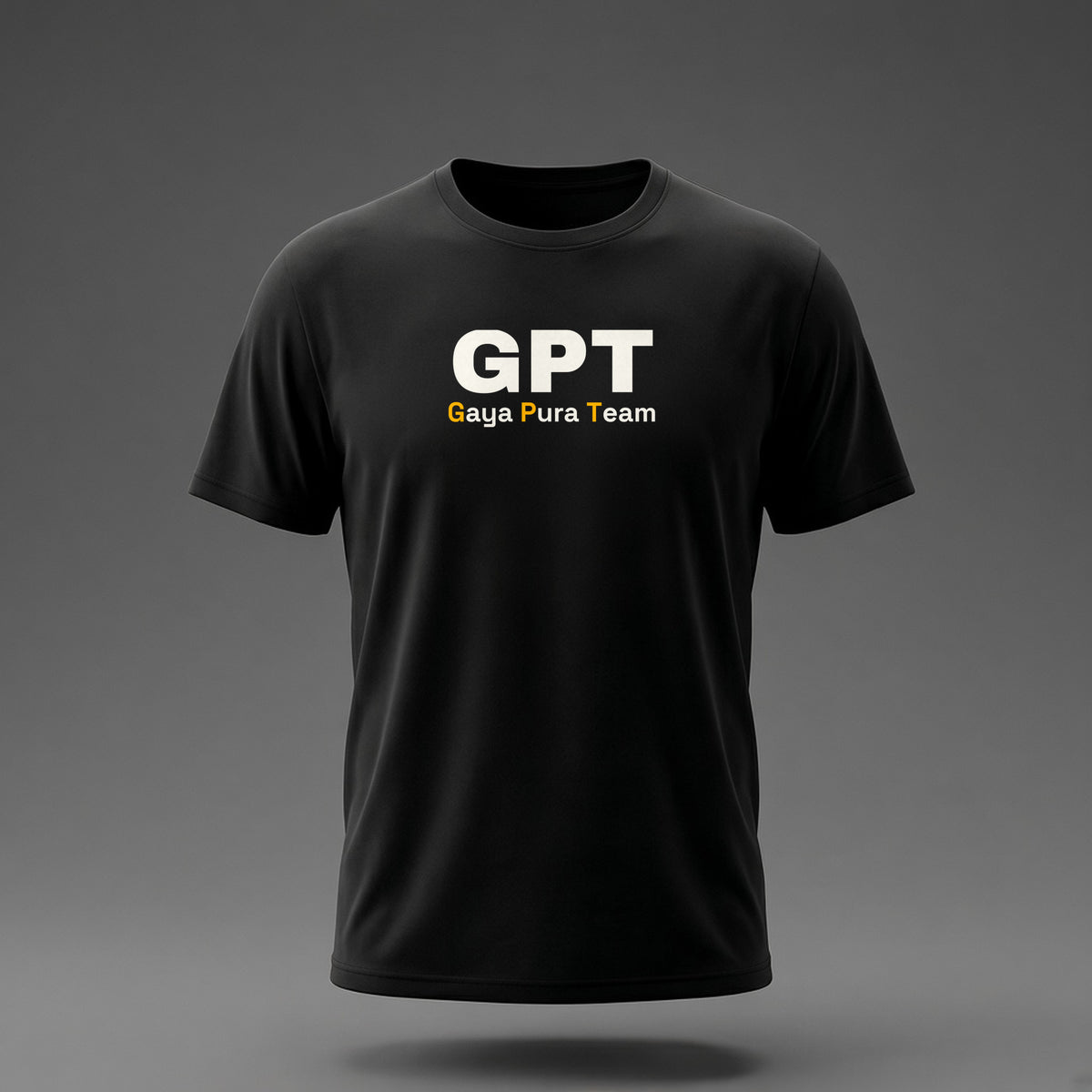 Front view: Black t-shirt floating on a grey background with a large three-letter acronym over the words 'Gaya Pura Team' printed across the chest in off-white and amber.