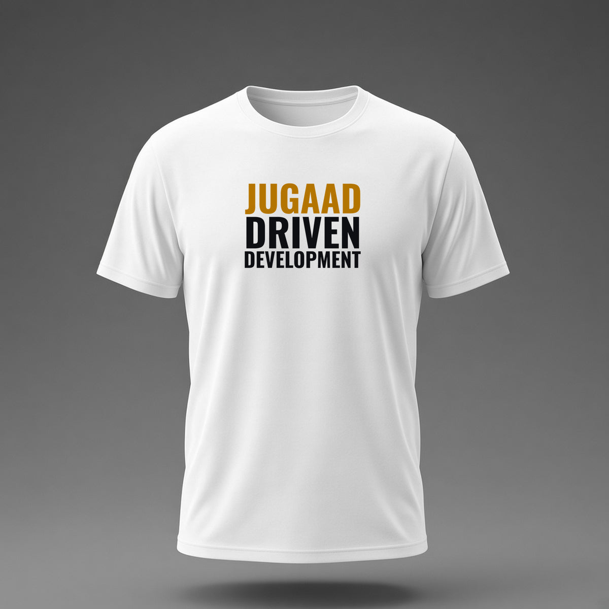 Front view: White t-shirt floating on a grey background with 'Jugaad Driven Development' as a justified stack printed across the chest in black and dark amber.