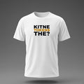 Front view: White t-shirt floating on a grey background with 'Kitne tokens the?' as a justified heavy stack printed across the chest in black and dark amber.