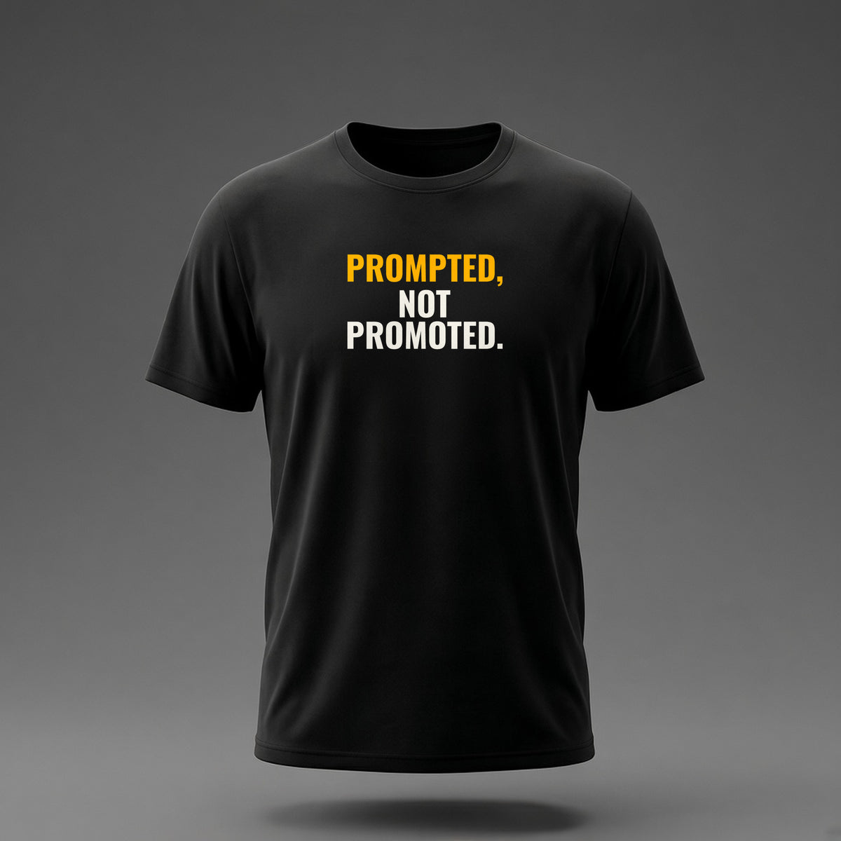 Front view: Black t-shirt floating on a grey background with 'Prompted, not promoted.' as a heavy condensed stack printed across the chest in off-white and amber.