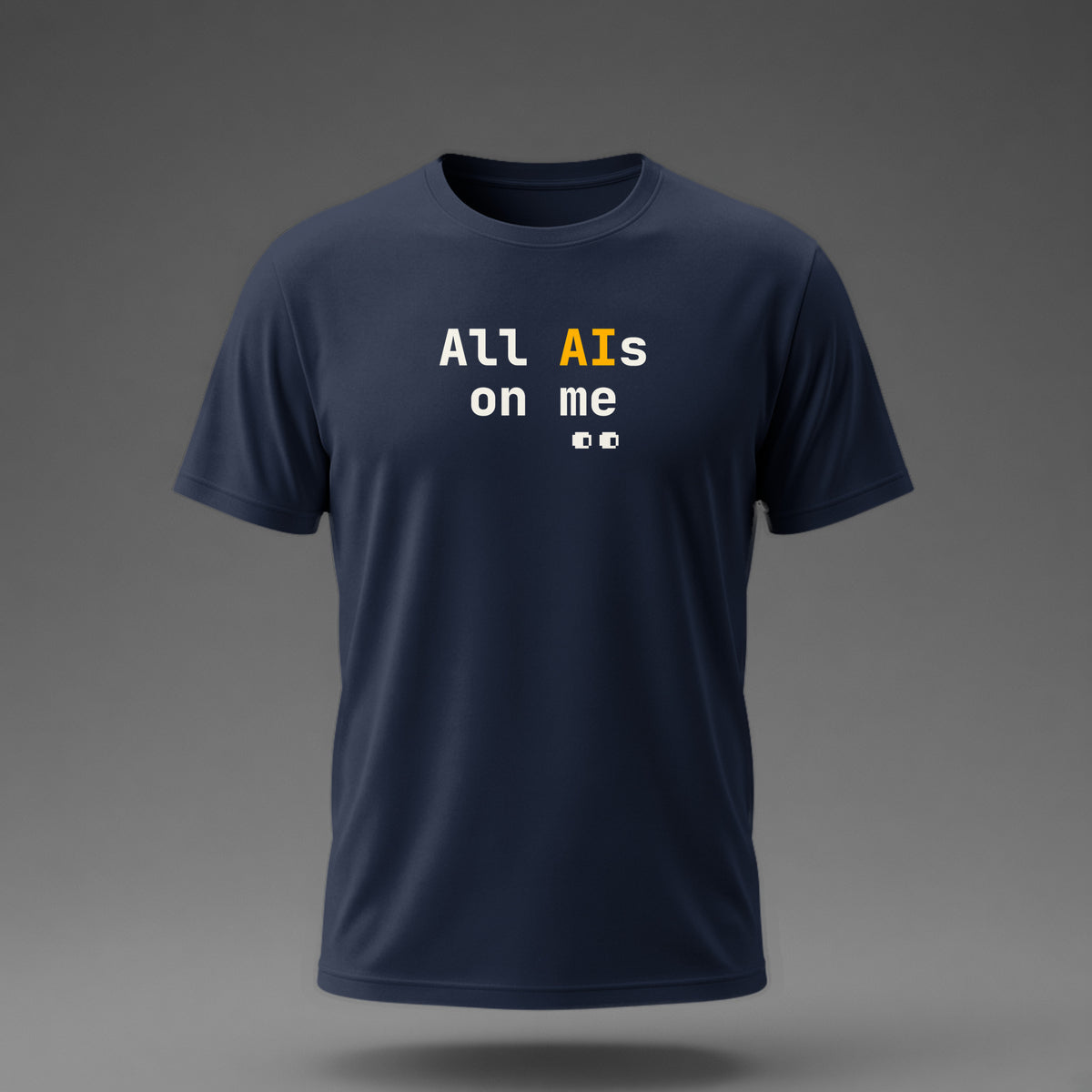 Front view: Navy t-shirt floating on a grey background with 'All AIs on me' stacked on two lines with small pixel eyes below printed across the chest in off-white and amber.