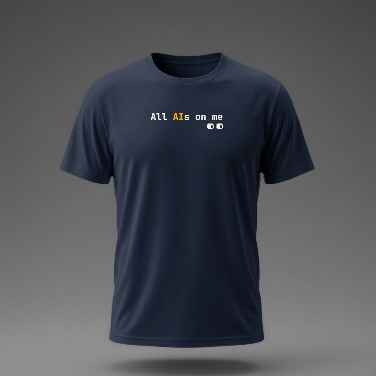 Front view: Navy t-shirt floating on a grey background with 'All AIs on me' on one line with pixel eyes printed across the chest in off-white and amber.
