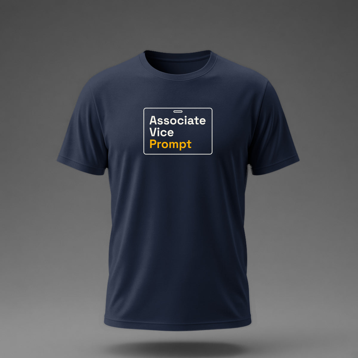 Front view: Navy t-shirt floating on a grey background with 'Associate Vice Prompt' on an ID-badge outline printed across the chest in off-white and amber.