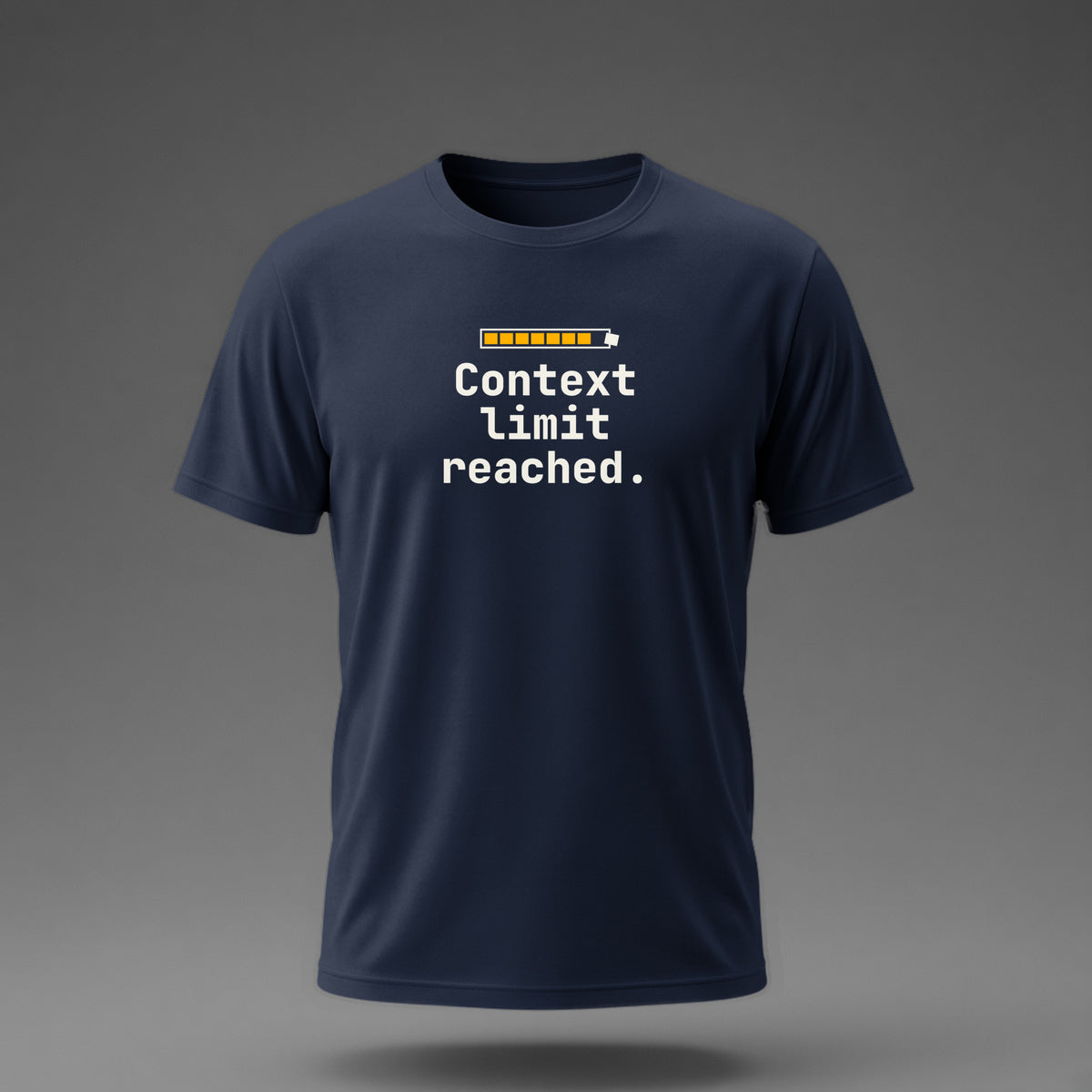 Front view: Navy t-shirt floating on a grey background with 'Context limit reached.' under a usage meter whose last block bursts out of the frame printed across the chest in off-white and amber.