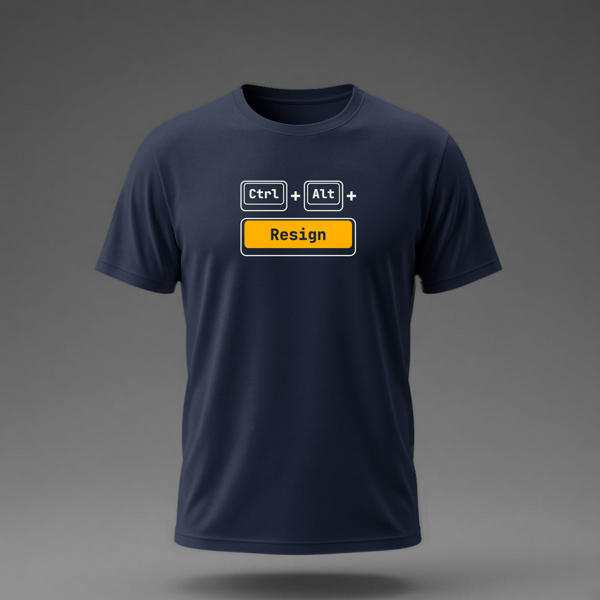 Front view: Navy t-shirt floating on a grey background with Ctrl and Alt keycaps over one wide 'Resign' key printed across the chest in off-white and amber.