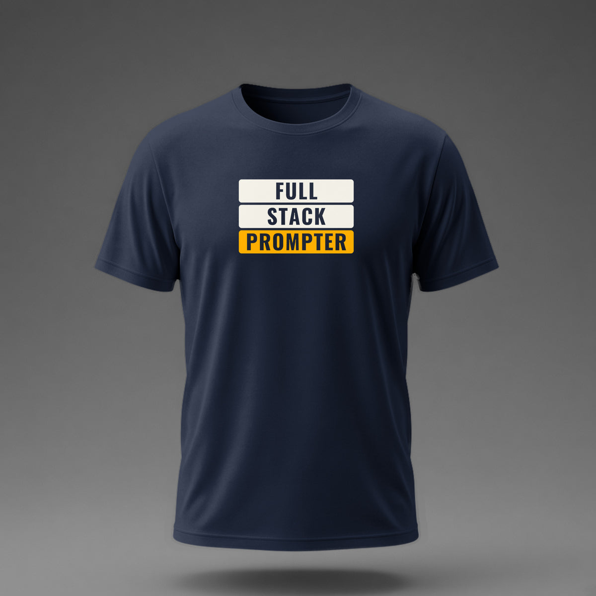 Front view: Navy t-shirt floating on a grey background with 'Full Stack Prompter' as three stacked slabs with the words knocked out printed across the chest in off-white and amber.