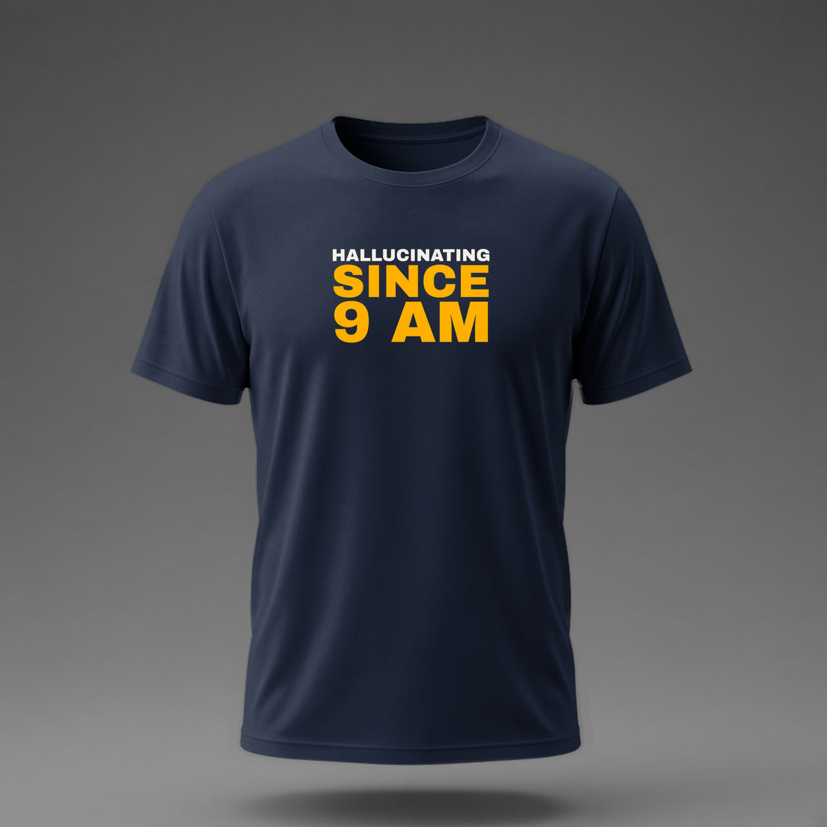 Front view: Navy t-shirt floating on a grey background with 'Hallucinating since 9 AM' as a justified stack printed across the chest in off-white and amber.