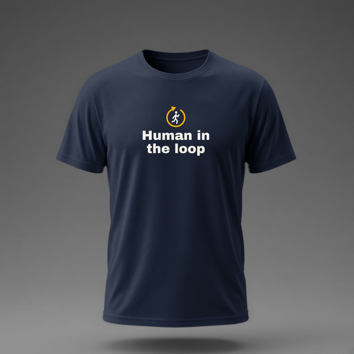 Front view: Navy t-shirt floating on a grey background with 'Human in the loop' under a stick human jogging inside a loop arrow printed across the chest in off-white and amber.