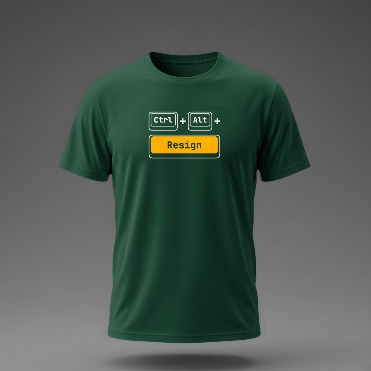 Front view: Bottle Green t-shirt floating on a grey background with Ctrl and Alt keycaps over one wide 'Resign' key printed across the chest in off-white and amber.