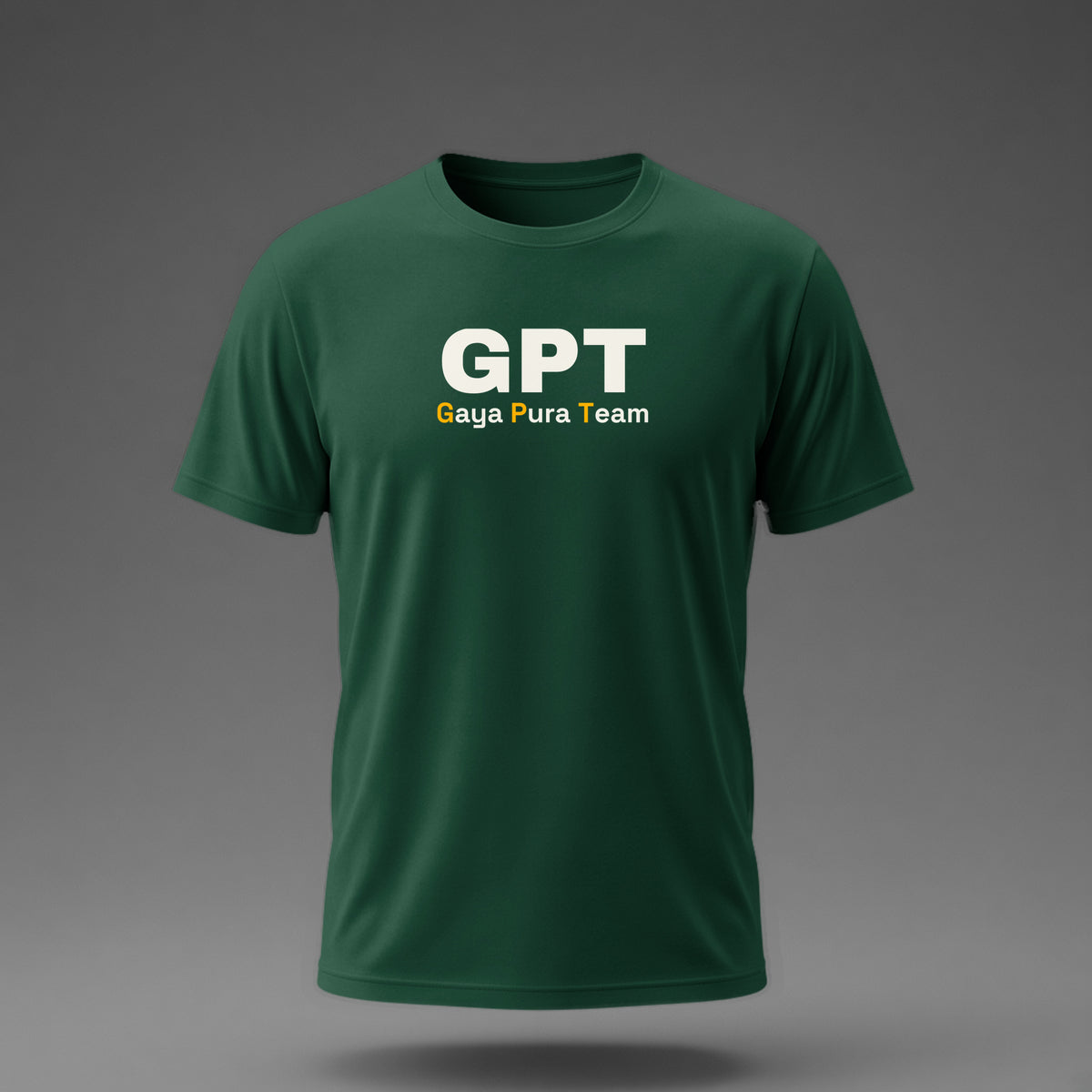 Front view: Bottle Green t-shirt floating on a grey background with a large three-letter acronym over the words 'Gaya Pura Team' printed across the chest in off-white and amber.