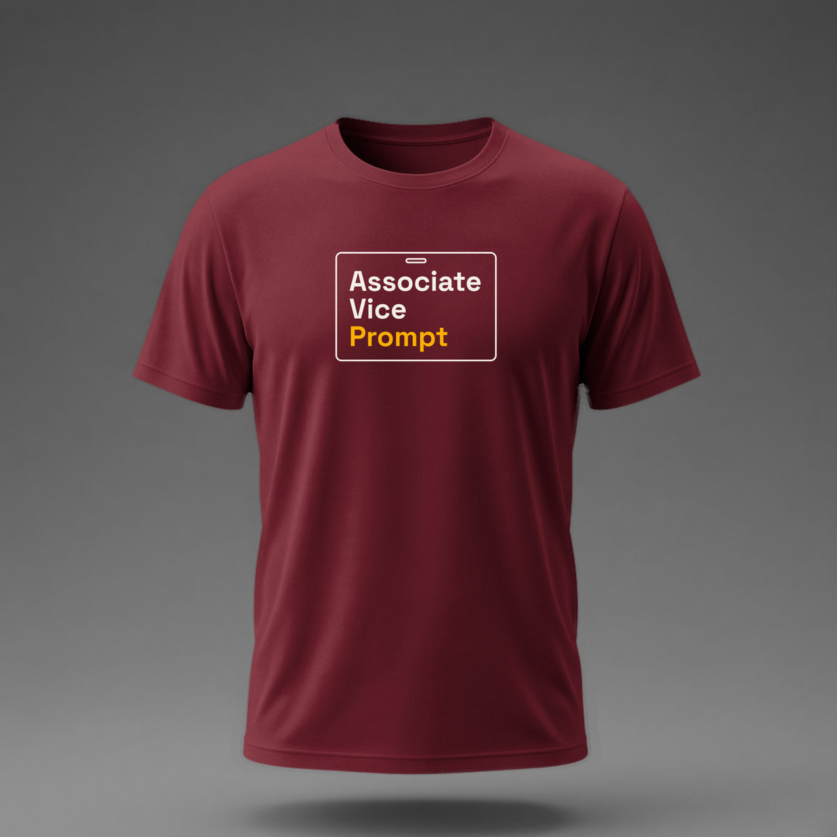 Front view: Maroon t-shirt floating on a grey background with 'Associate Vice Prompt' on an ID-badge outline printed across the chest in off-white and amber.