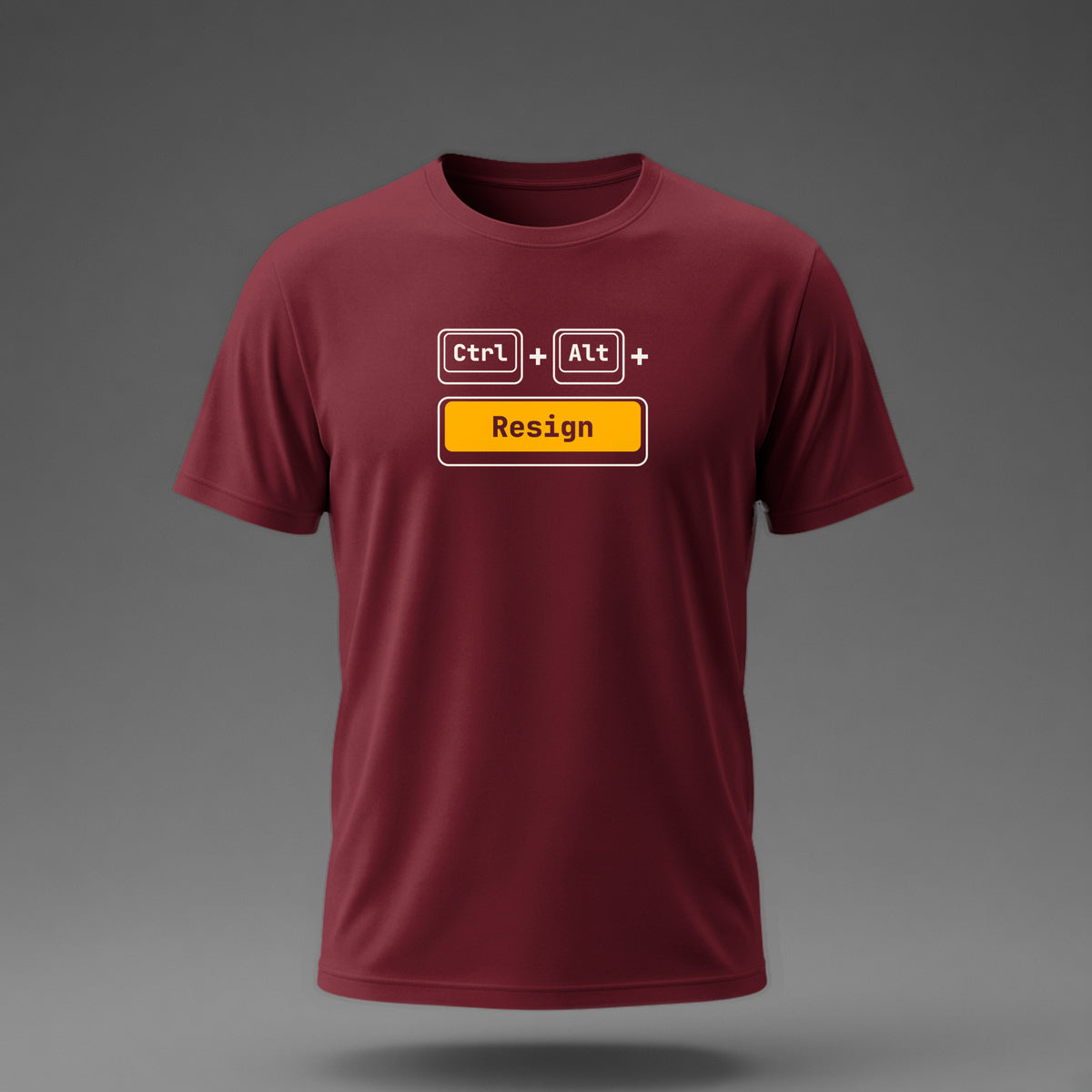 Front view: Maroon t-shirt floating on a grey background with Ctrl and Alt keycaps over one wide 'Resign' key printed across the chest in off-white and amber.