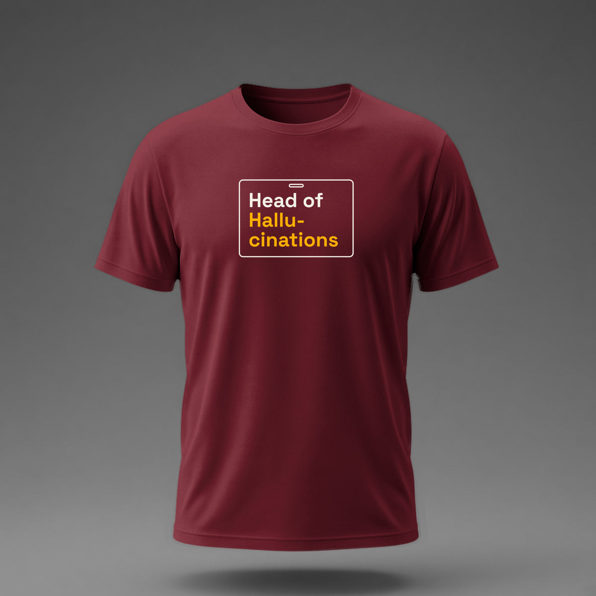 Front view: Maroon t-shirt floating on a grey background with 'Head of Hallucinations' on an ID-badge outline printed across the chest in off-white and amber.